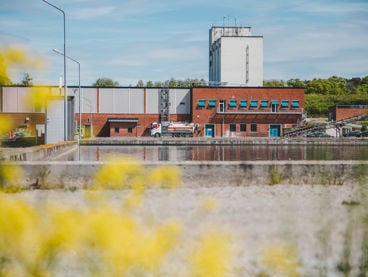 Ett reningsverk med en stor utomhusbassäng för vattenrening framför.